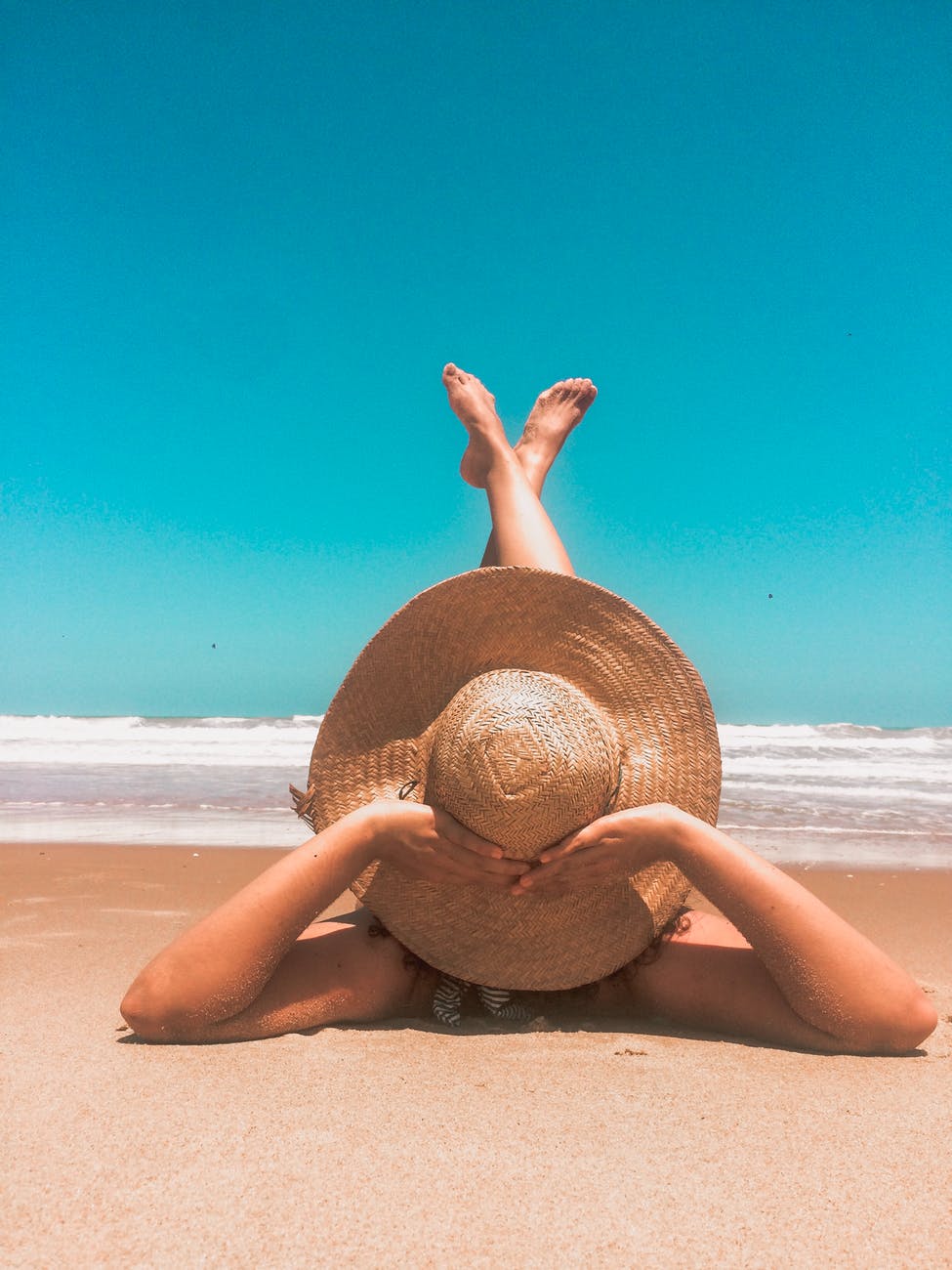 person laying on sand